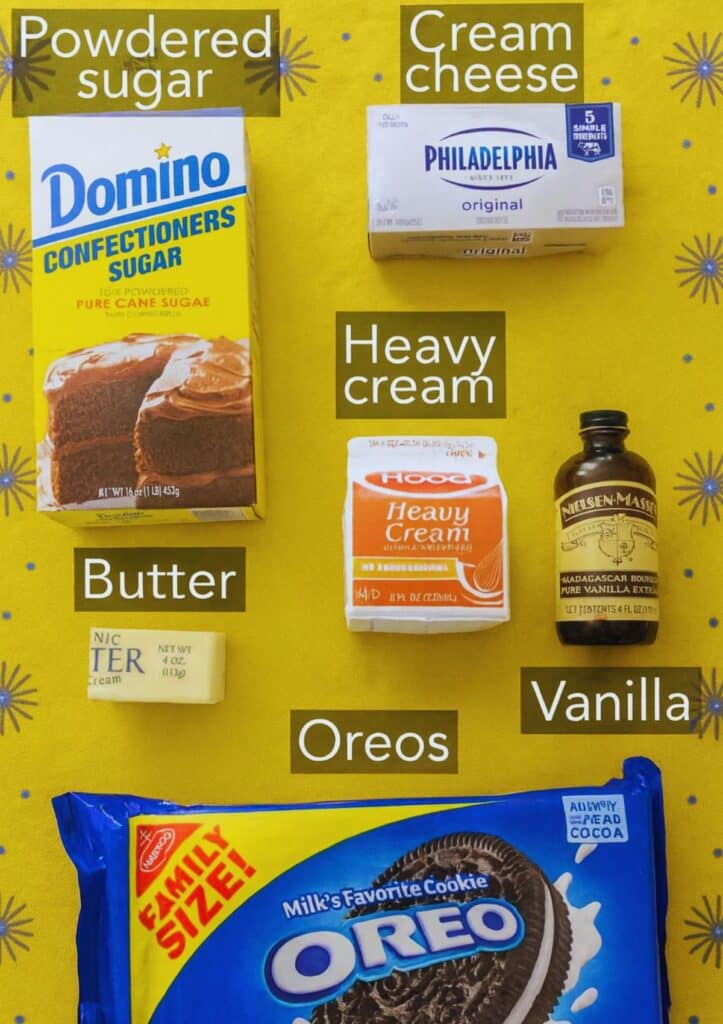 Oreo pie ingredients including powdered sugar, cream cheese, heavy cream, butter, vanilla, and Oreos on a yellow background