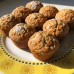 Carrot muffins on a yellow plate with golden sunburst rim