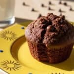 Chocolate muffin on plate with golden sunburst rim