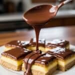 Pouring chocolate ganache over Nanaimo Bars