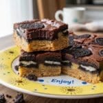 Slutty Brownies layered dessert bars with cookie dough, Oreos, and brownies