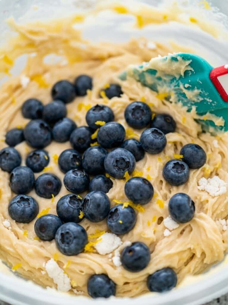 Folding blueberries into lemon muffin batter