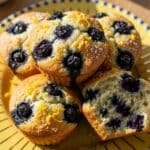 Lemon blueberry muffins on yellow plate with golden sunburst rim