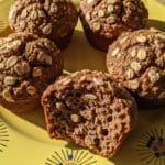 Bran muffins cooling on yellow plate with close-up crumb texture