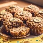 Banana Oatmeal Muffins on a yellow plate with golden sunbursts and blue dots