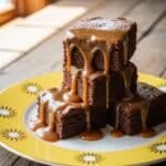 caramel brownies stacked on a wooden table
