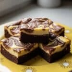 Cheesecake Brownies hero image with creamy swirl and fudgy chocolate base