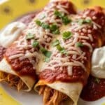 Chicken Enchiladas served on a yellow plate with golden sunbursts