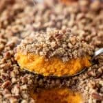 Close-up texture of Sweet Potato Casserole with golden pecan topping