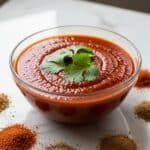 Homemade Enchilada Sauce in Glass Bowl with Cilantro