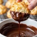 Dipping coconut macaroons in melted chocolate