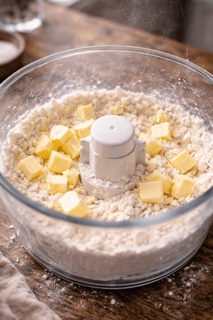adding cold butter cubes to flour for pie crust recipe