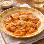Cheese Ravioli served with sauce and parmesan on a yellow plate