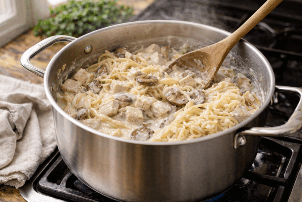 Mixing Chicken Tetrazzini ingredients