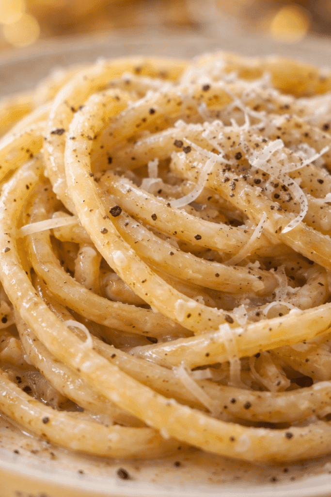 Close-up of creamy Cacio E Pepe pasta with black pepper